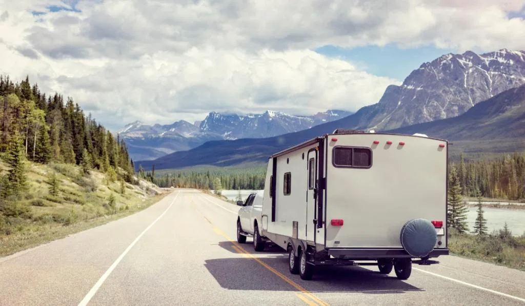Caravan or motor home trailer on a mountain road 