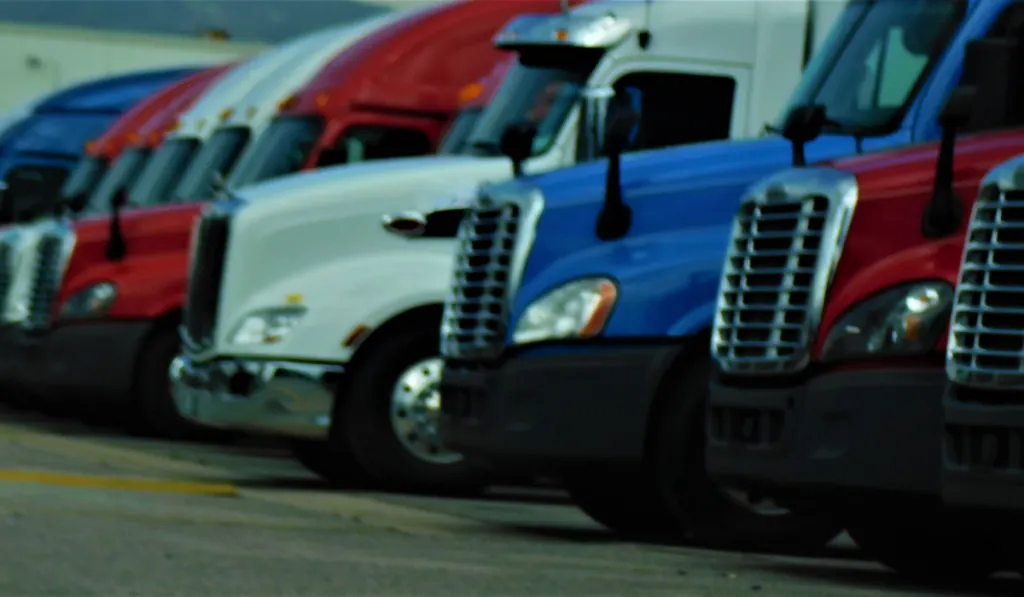 Red, White and Blue Big Rig Semi Trucks parked