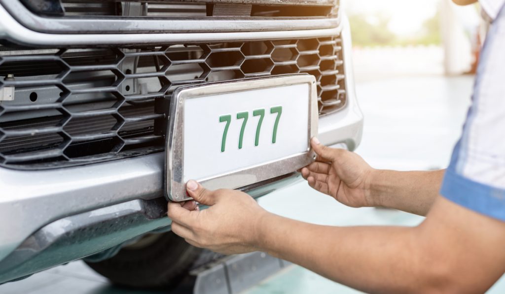 Technician changing plate number