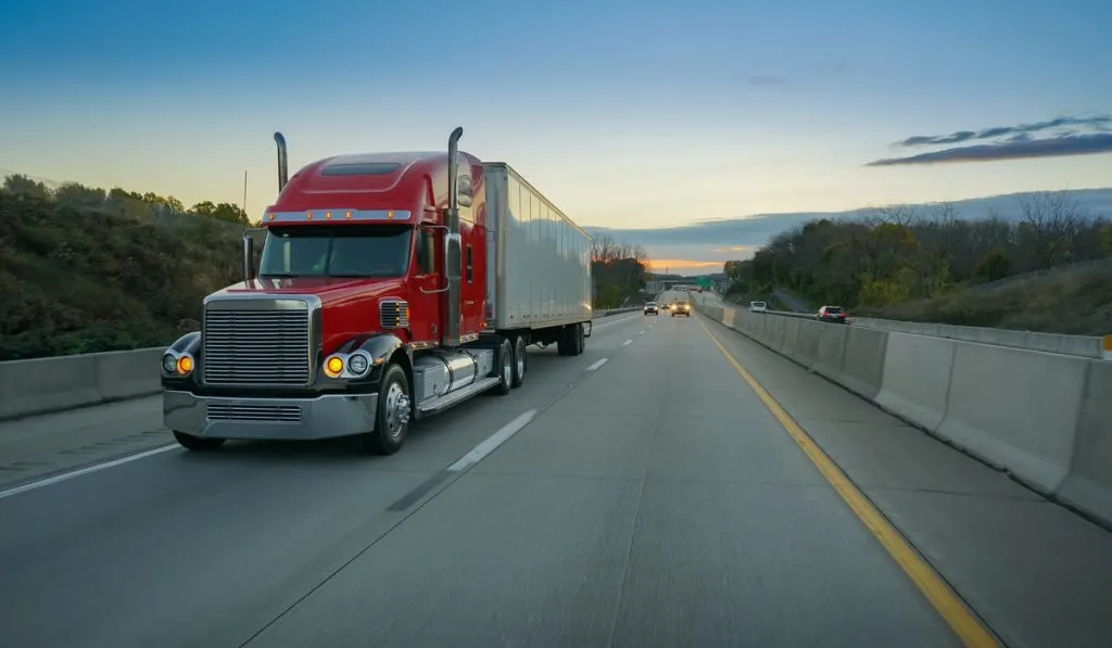 big red semi-truck on highway