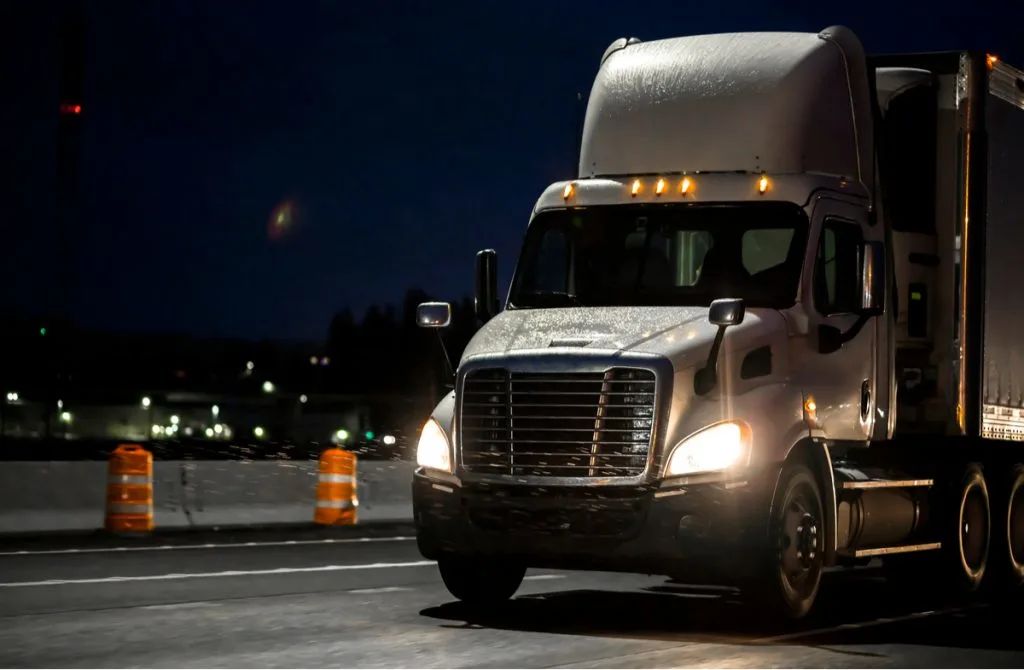 big white semi-truck on road night view