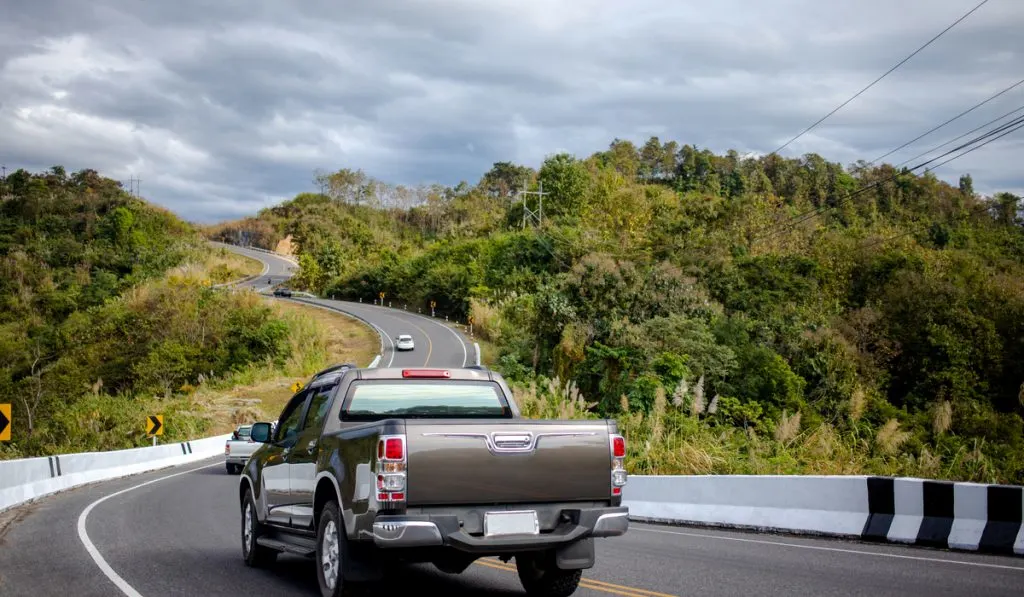 black pickup truck n beautiful road long road 