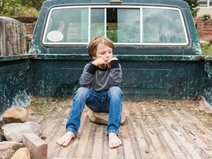 boy-posing-in-the-bed-of-an-old-pick-up-truck