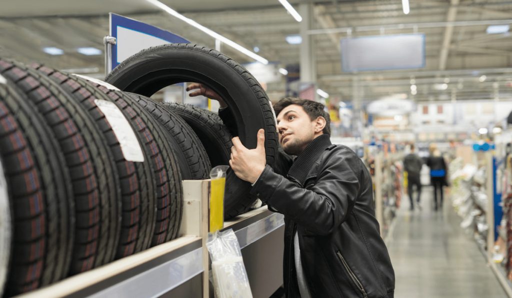 male customer choosing new tires that are compatible for lift kit