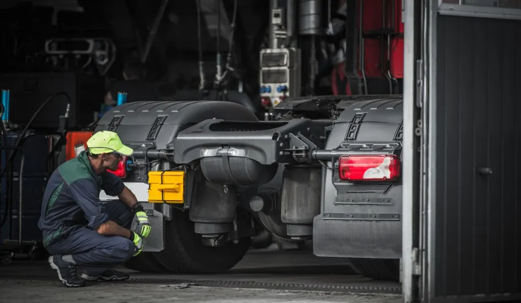 service mechanic checking truck 