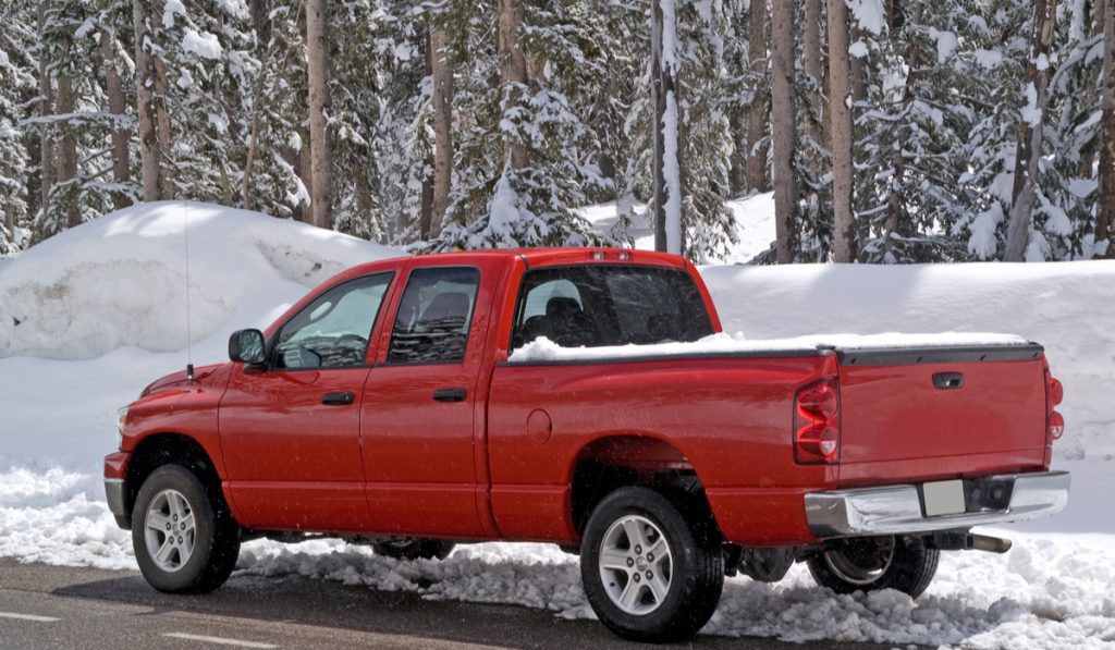 shiny red pickup truck depth snow road 