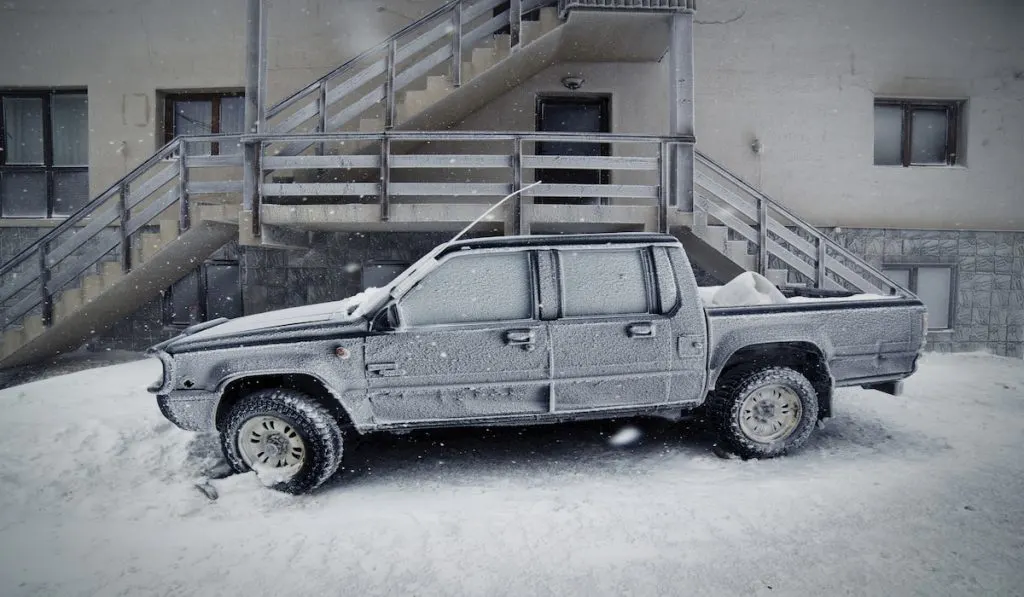 Pick-up Truck Covered With Snow By Staircase