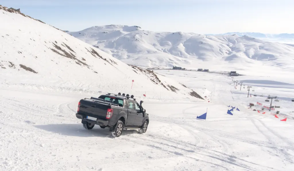 Pick Up Truck on snow at top of the mountain